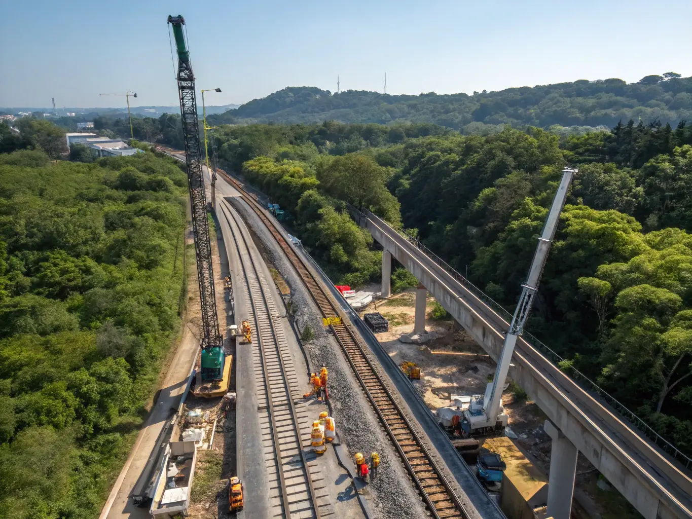 An aerial view of a metro railway construction site, emphasizing complex infrastructure and system integration.