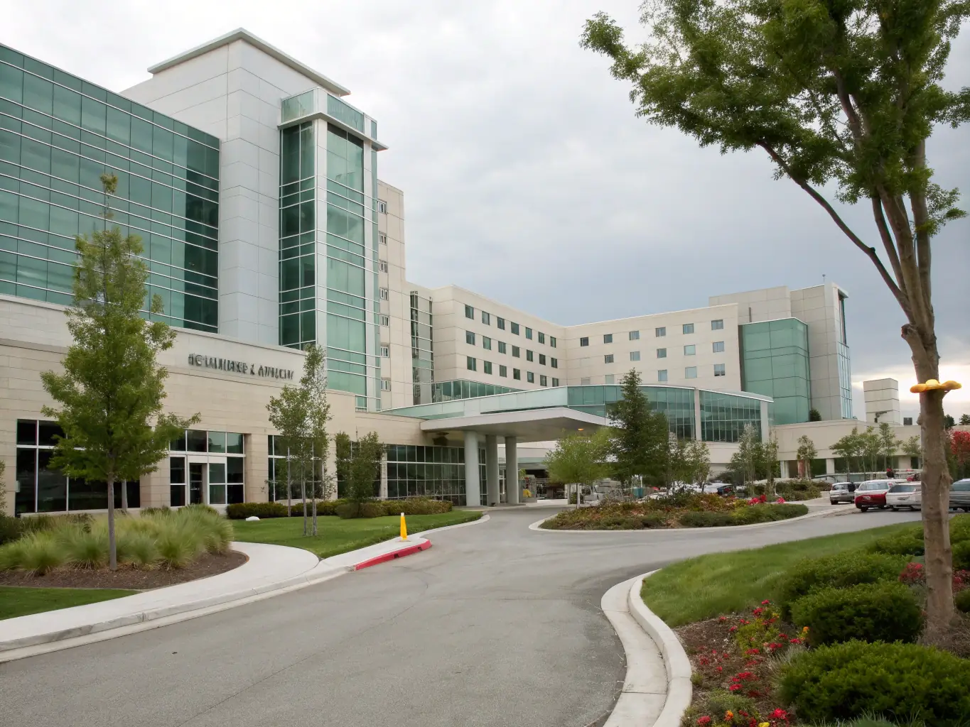 A modern hospital building exterior with glass facade, showcasing advanced MEP systems integration.